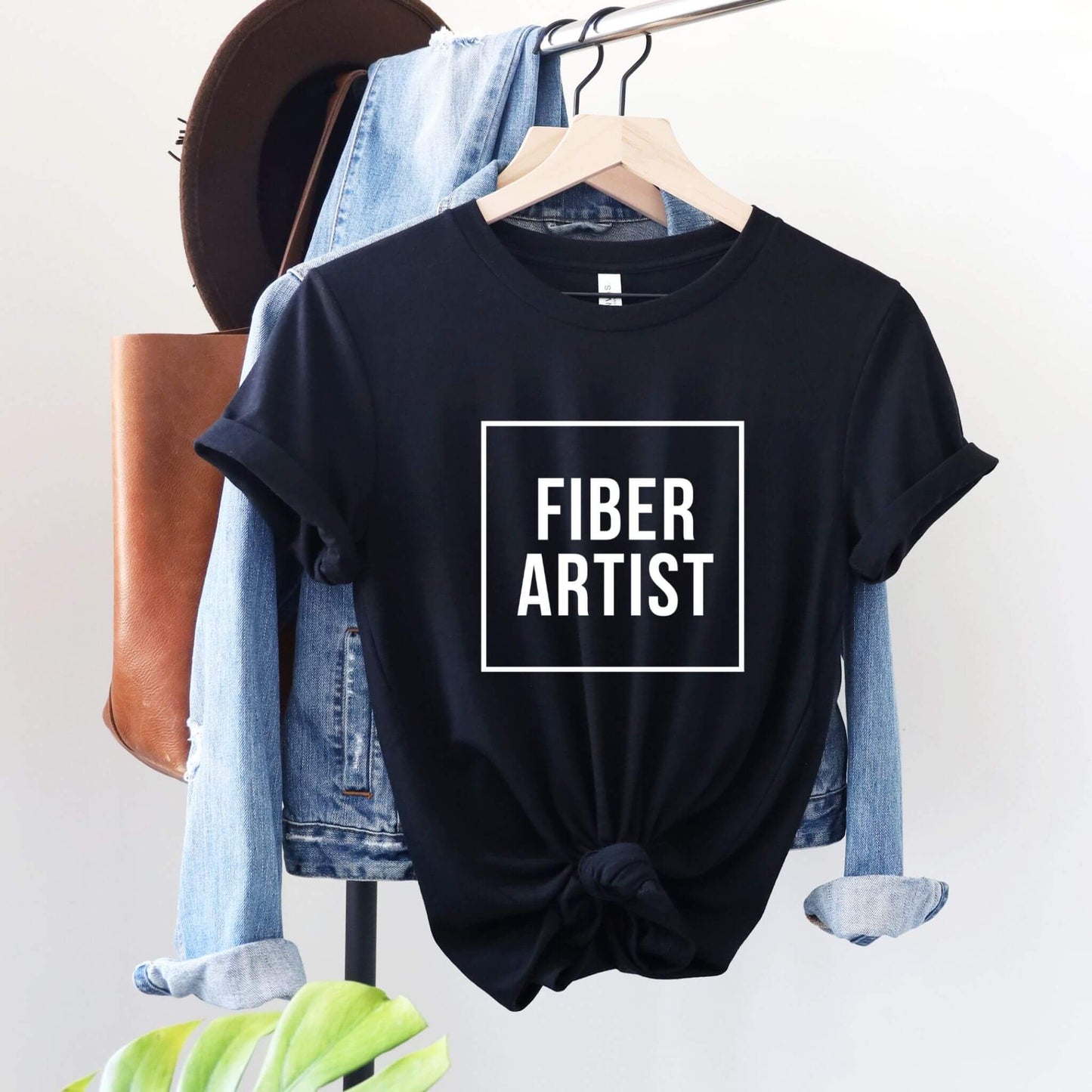 black t-shirt with words fiber artist on it