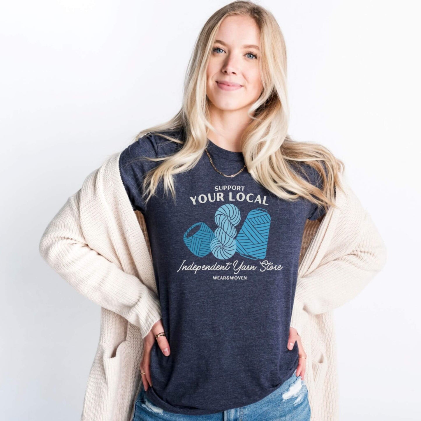 support your local independent yarn store dark heather blue t-shirt. shirt has three images of yarn in different shades of blue